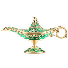 a gold and green teapot on a white background