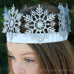 a woman wearing a tiara with snowflakes on it