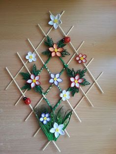 a wooden table topped with lots of flowers and sticks in the shape of an x