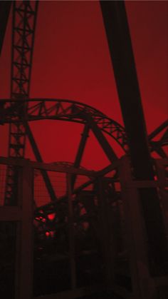 the sky is red and there are many roller coasters