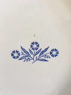 a blue and white plate with flowers on it