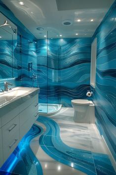 a bathroom with blue waves painted on the walls and floor, along with two sinks