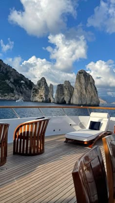 chairs and tables on the deck of a boat