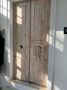 an open wooden door in a white room