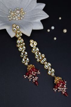 These earrings are a traditional piece rendered in contemporary style and a perfect conversation starter for every occasion you grace. Closure - Push Back Style Tip - Wear this with almost anything Indian for a rich and royal look because nothing more regal than kundan earrings. We love teaming this with classy chiffon sarees or zari silk sarees. Also looks best when worn with your royal whites, off whites and gold. We recommend styling with bold solids or floral dresses in peachy pink, pistachi Festive Dual-tone Chandbalis, Festive Dual-tone Danglers, Red Kundan Chandbalis In Fusion Style, Festive Dual-tone Danglers For Celebration, Red Fusion Chandbalis For Celebration, Red Fusion Style Chandbalis For Celebration, Red Fusion Style Chandbalis For Diwali, Red Fusion Bridal Earrings For Festive Occasions, Red Cutdana Chandbalis For Festive Occasions