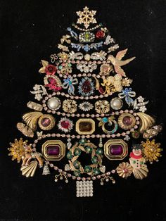 a christmas tree made out of jewelry on a black background