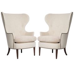 a pair of white chairs sitting next to each other