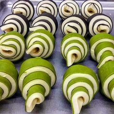 green and white striped pastries sitting on top of a metal pan