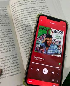 an mp3 player is sitting next to an open book