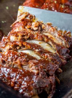 ribs covered in bbq sauce and garnished with parmesan cheese