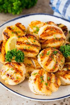 grilled scallops with lemon and parsley on a plate