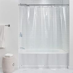 a white bathroom with a shower and toilet