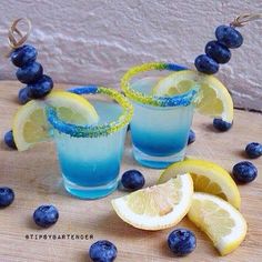 two glasses filled with blueberries and lemons