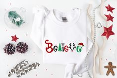 Celebrate the magic of the holiday season with this "Believe" Christmas T-Shirt. Perfect for Christmas parties, family gatherings, or any festive occasion, this shirt embodies the spirit of Christmas with its simple yet powerful message. The word "Believe" is beautifully displayed, reminding everyone of the joy, hope, and wonder that comes with the season. Made from soft, high-quality fabric, this shirt is comfortable to wear and easy to style with your favorite holiday outfits. Whether you're looking for a Christmas family shirt or a special gift, this "Believe" Christmas Shirt is sure to bring holiday cheer to anyone who wears it. Welcome to Authentic Tee! Discover  your  dream style in our store, where we offer unique designs through DTF printing on high-quality apparel. Our soft and co Festive Long Sleeve White T-shirt, College Letters, Christmas Believe, Christmas Party Shirt, Christmas Family Shirt, Believe Christmas, Text Shirt, Dtf Printing, Family Christmas Shirts