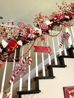 some candy canes are hanging on the banister