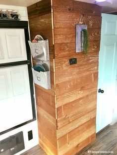 the inside of a mobile home with wood paneling on the walls and door handles