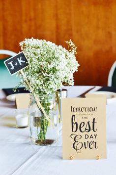 a vase filled with baby's breath sitting on top of a table