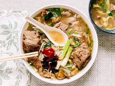 a bowl of soup with meat, noodles and vegetables