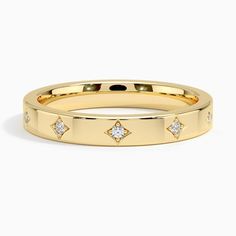 a yellow gold ring with diamonds on it