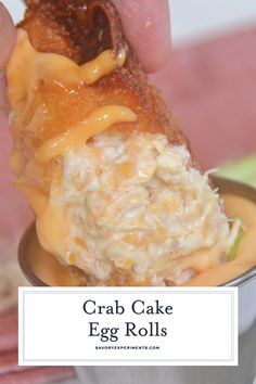 crab cake egg rolls in a small bowl with sauce on the side and text overlay that reads crab cake egg rolls