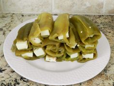 stuffed green peppers with cheese on a white plate