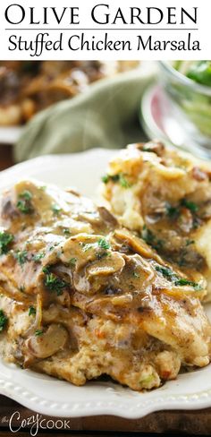 chicken masala with mushrooms and parsley on a white plate, next to a green salad