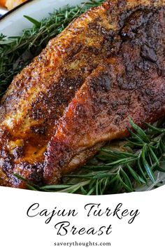 a close up of a piece of meat on a plate with rosemary sprigs