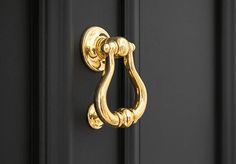 a black door with a gold handle on it