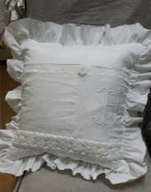 a white pillow sitting on top of a bed