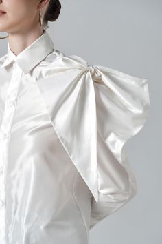 With a large size bowtie detail at the shoulder, the classic shirt now stands out like never before. High-quality silk material is selected to bring a moderate shine to the surface and created an impressive visual effect for the product. Note:*Processing time takes 7-10 working days (including 3-5 working days for manufacturing and NOT including shipping time)**Backorder Definition- The product is low in stock and in case the customer purchased successfully after out of stock, the order will nee Elegant Silk Shirt For Daywear, Elegant Silk Tops With Bow Detail, Elegant Silk Tops With Bow, Silk Party Blouse With Pleated Sleeves, Silk Blouse With Pleated Sleeves For Party, Elegant Summer Blouse With Bow, Elegant Satin Shirt For Spring, Chic Long Sleeve Shirt With Bow, Silk Party Tops With Pleated Sleeves