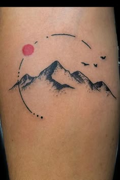 a tattoo with mountains and birds on it