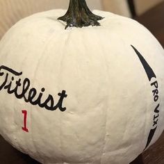 a white pumpkin with the word contest painted on it's side and a tree in the middle