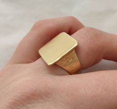 A beautiful statement piece in 18k solid Hammered textured Gold. A subtle yet unique statement piece. A natural and organic feeling to the gold and the style. Unique square signet ring Specifications: * Upper square part: about 18.5 X 18.5 mm * Band width: tapering between 12mm and 3.5mm * Weight: about 10g ◈ MATERIAL 18K Solid Yellow Gold ◈ ALSO AVAILABLE IN 14K in yellow, rose and white gold 18K Rose and White Gold 22K Solid Yellow gold ◈ ENGRAVING is optional for $7 per letter/number/characte Square Gold Ring, Wide Wedding Rings, Handmade Gold Ring, Beautiful Wedding Bands, Rustic Rings, Hammered Earrings, Gold Statement Ring, Gold Engraving, Etsy Gold Ring