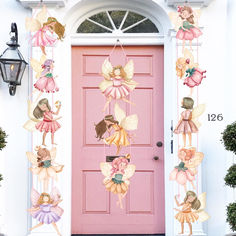 a pink front door decorated with fairy tinkerbells