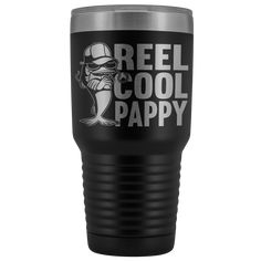 a black and silver tumbler with the words reel cool daddy on it, in white lettering