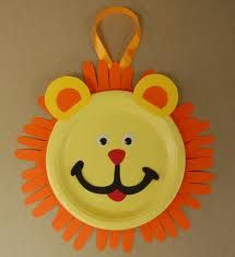 a paper plate with a lion face on it and a yellow lanyard hanging from the side