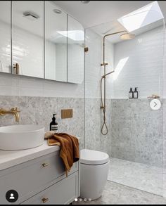 a bathroom with a sink, toilet and shower in the middle of it's walls