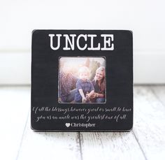 a black photo frame with the words uncle and an image of a baby in it