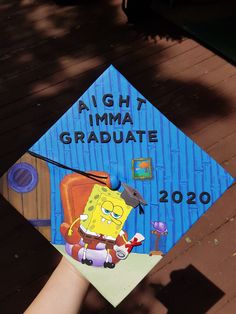 a blue graduation cap with an image of spongebob on it that says, aght imma graduate