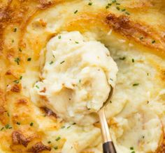 mashed potatoes in a casserole dish with a spoon