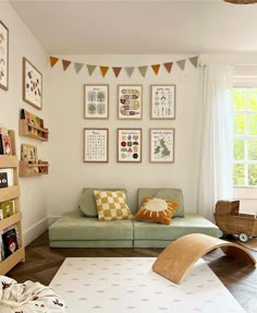 a living room filled with furniture and pictures on the wall