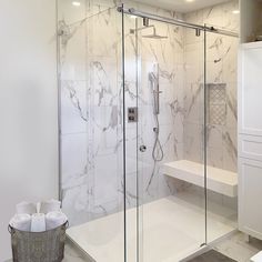 a walk in shower sitting next to a white sink and counter top under a mirror