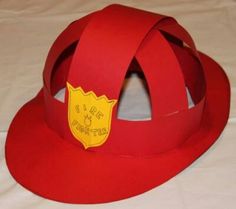 a red fireman's hat made out of paper with a yellow badge on it