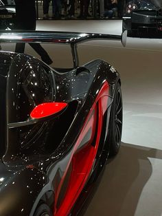 a black and red sports car is on display