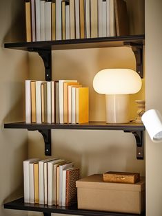 a lamp and some books on a shelf