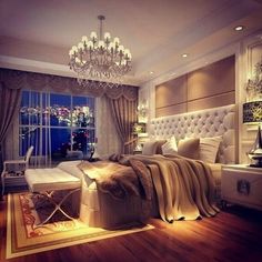 a bedroom with a large bed and a chandelier hanging from the ceiling