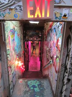 an exit with graffiti all over the walls