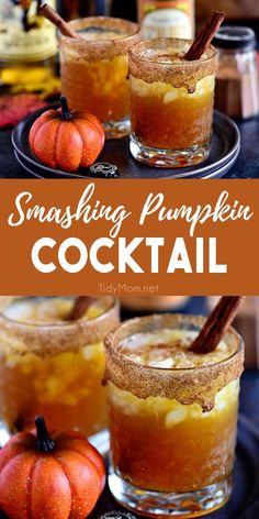 two glasses filled with drinks sitting on top of a table next to pumpkins and cinnamon sticks