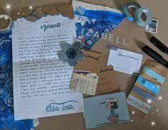 the contents of a scrapbook spread out on a table with scissors, tape and other items