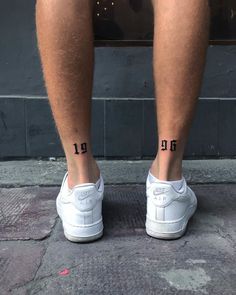 a man's legs with the number thirteen tattooed on them